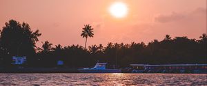 Preview wallpaper sunset, waves, water, boat, palm trees