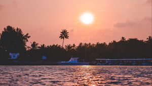 Preview wallpaper sunset, waves, water, boat, palm trees