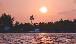 Preview wallpaper sunset, waves, water, boat, palm trees