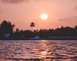 Preview wallpaper sunset, waves, water, boat, palm trees