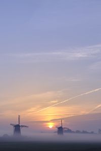 Preview wallpaper sunset, windmills, fog, dusk, landscape