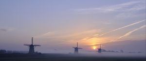 Preview wallpaper sunset, windmills, fog, dusk, landscape