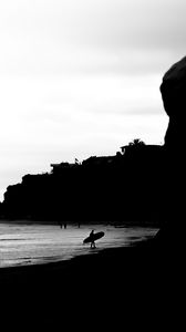 Preview wallpaper surfing, surfer, bw, coast, rocks