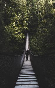 Preview wallpaper suspension bridge, bridge, man, trees, forest