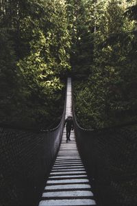 Preview wallpaper suspension bridge, bridge, man, trees, forest