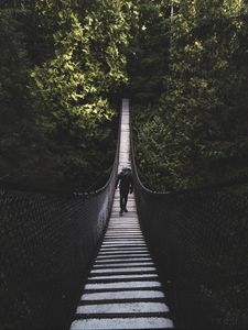 Preview wallpaper suspension bridge, bridge, man, trees, forest