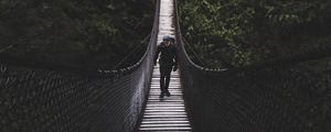 Preview wallpaper suspension bridge, bridge, man, trees, forest