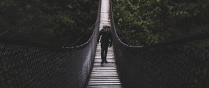 Preview wallpaper suspension bridge, bridge, man, trees, forest