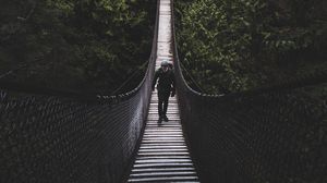 Preview wallpaper suspension bridge, bridge, man, trees, forest