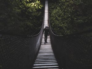 Preview wallpaper suspension bridge, bridge, man, trees, forest