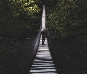 Preview wallpaper suspension bridge, bridge, man, trees, forest