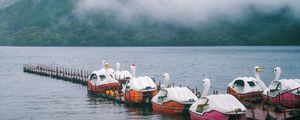 Preview wallpaper swans, boats, pier, lake, mountains, fog