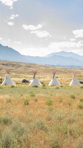 Preview wallpaper teepee, grass, valley, mountains, nature