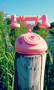 Preview wallpaper telephone, toy, grass, river, trees