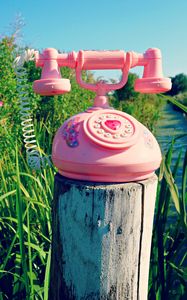 Preview wallpaper telephone, toy, grass, river, trees