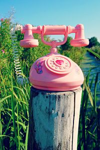 Preview wallpaper telephone, toy, grass, river, trees