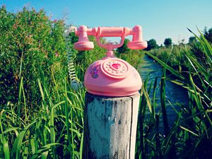 Preview wallpaper telephone, toy, grass, river, trees