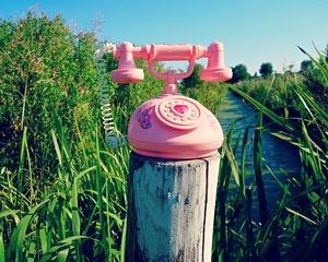 Preview wallpaper telephone, toy, grass, river, trees