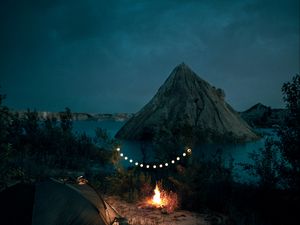 Preview wallpaper tent, camping, campfire, garland, rocks