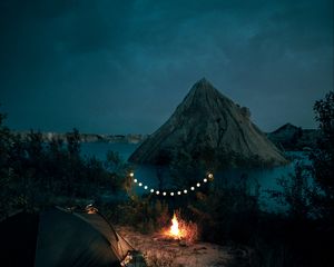 Preview wallpaper tent, camping, campfire, garland, rocks