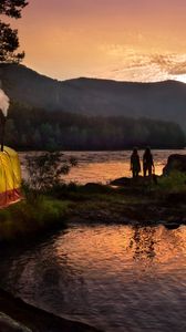 Preview wallpaper tent, wood, lake, girls, silhouettes, mountains, pipe, evening