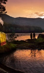 Preview wallpaper tent, wood, lake, girls, silhouettes, mountains, pipe, evening