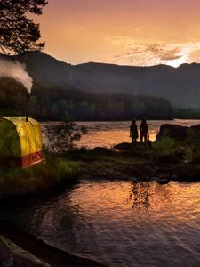 Preview wallpaper tent, wood, lake, girls, silhouettes, mountains, pipe, evening