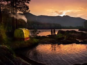 Preview wallpaper tent, wood, lake, girls, silhouettes, mountains, pipe, evening