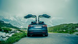 Preview wallpaper tesla, car, black, road, mountains