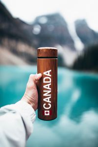Preview wallpaper thermos, hand, inscription, brown, wooden