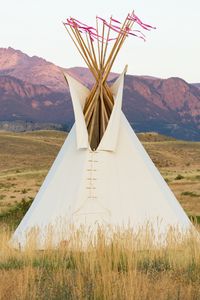 Preview wallpaper tipi, grass, valley, mountains