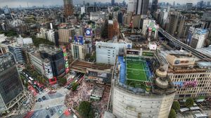 Preview wallpaper tokyo, house, football, metropolis, field, people, roofs, crowds, japan, road, hdr