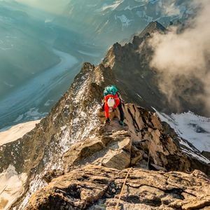 Preview wallpaper tourist, traveler, climber, mountains, rocks, snow