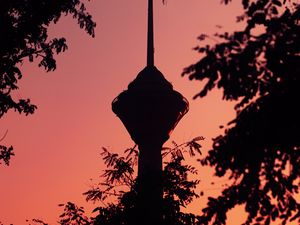 Preview wallpaper tower, building, dark, branches, dusk