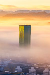 Preview wallpaper tower, building, fog, mountains, valley