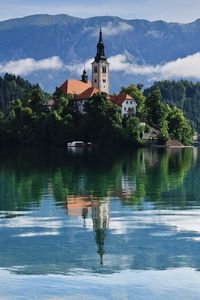 Preview wallpaper tower, building, lake, reflection, mountains