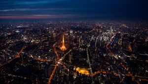 Preview wallpaper tower, buildings, city, lights, roads, aerial view