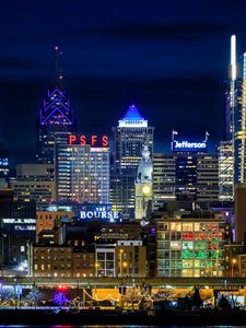 Preview wallpaper tower, buildings, lights, inscriptions, night, city