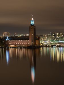 Preview wallpaper tower, buildings, lights, glow, river, night, city