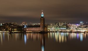 Preview wallpaper tower, buildings, lights, glow, river, night, city