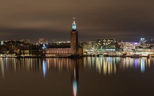 Preview wallpaper tower, buildings, lights, glow, river, night, city