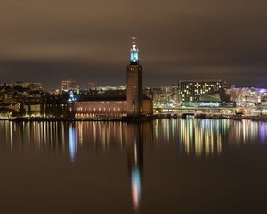 Preview wallpaper tower, buildings, lights, glow, river, night, city