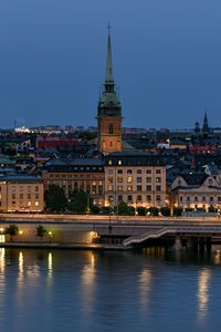 Preview wallpaper tower, buildings, lights, embankment, river, twilight