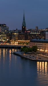 Preview wallpaper tower, buildings, lights, embankment, river, twilight, city
