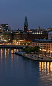 Preview wallpaper tower, buildings, lights, embankment, river, twilight, city