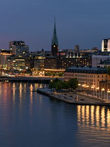 Preview wallpaper tower, buildings, lights, embankment, river, twilight, city