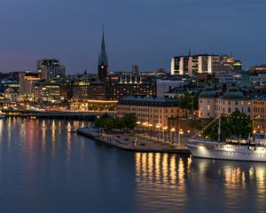 Preview wallpaper tower, buildings, lights, embankment, river, twilight, city