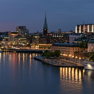 Preview wallpaper tower, buildings, lights, embankment, river, twilight, city