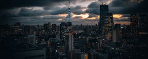 Preview wallpaper tower, buildings, lights, city, twilight, clouds