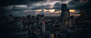 Preview wallpaper tower, buildings, lights, city, twilight, clouds